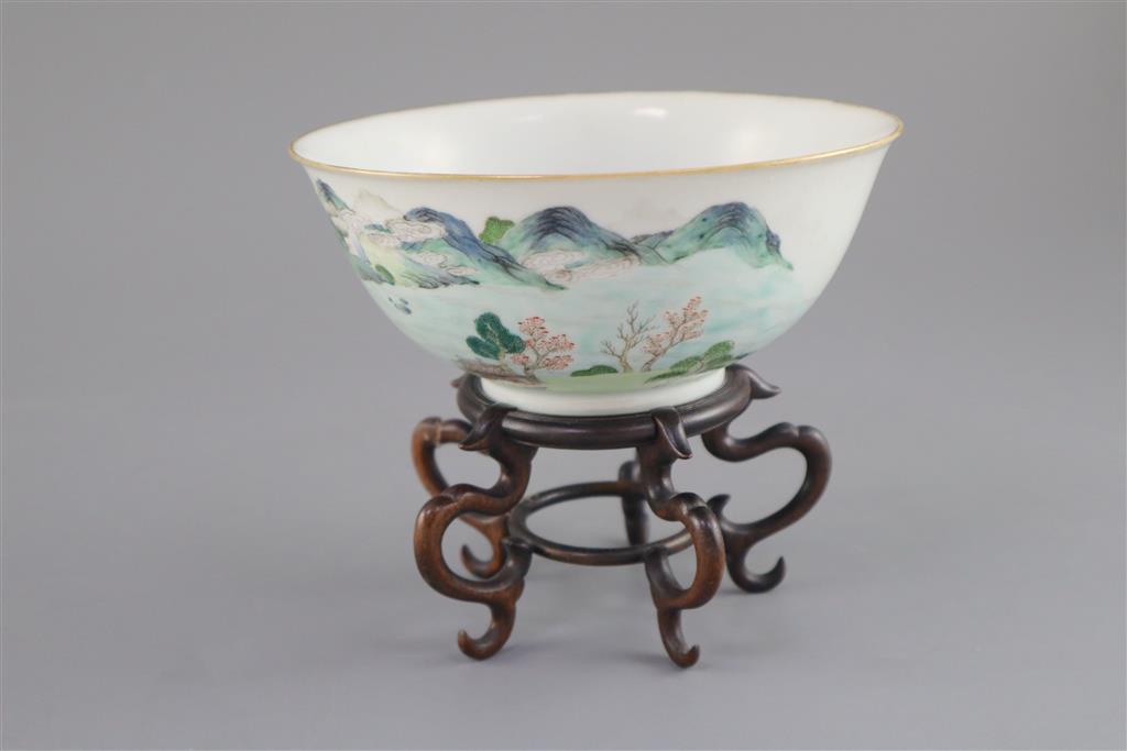 A Chinese enamelled landscape porcelain bowl, Jiaqing mark and of the period (1796-1820), 15.5cm diameter, wood stand